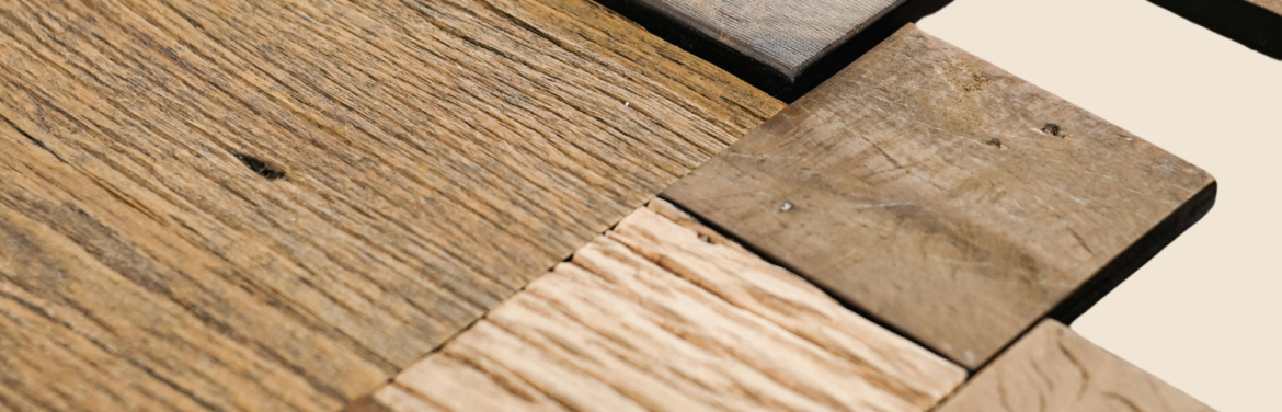 Various types of hardwood flooring displayed, showcasing different finishes, colors, and textures for home or office spaces.