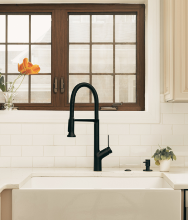 Kitchen sink with newly installed tile backsplash, featuring a stylish design that complements the kitchen's decor.